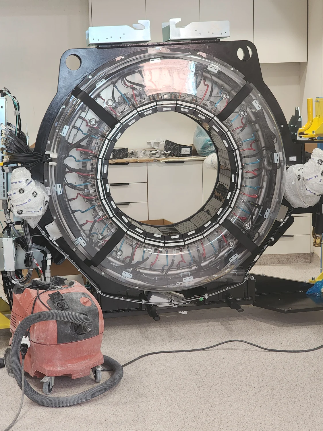 The exposed mechanical and electronic components inside a CT gantry.