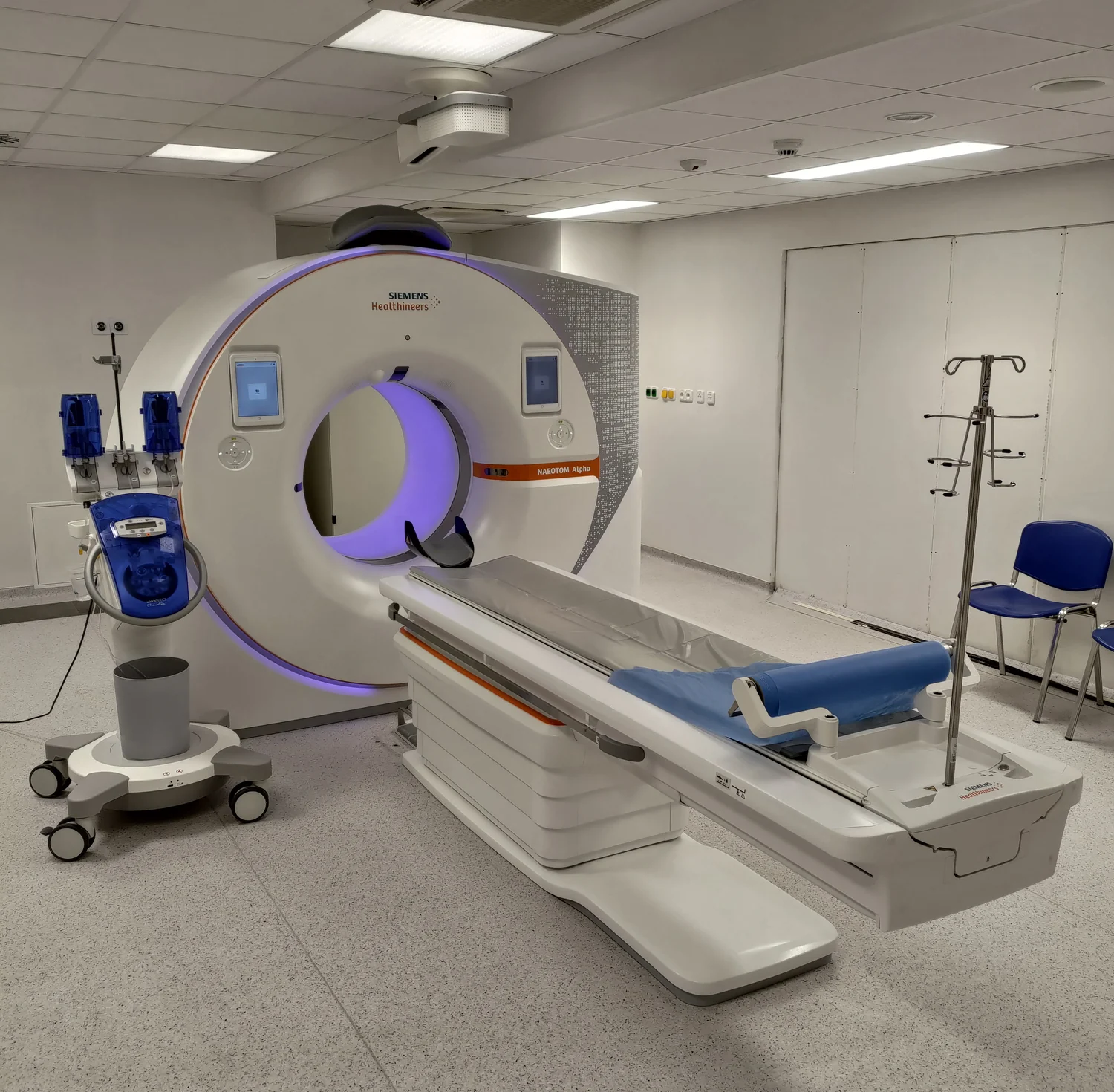 A modern CT scanner in a hospital imaging suite.
