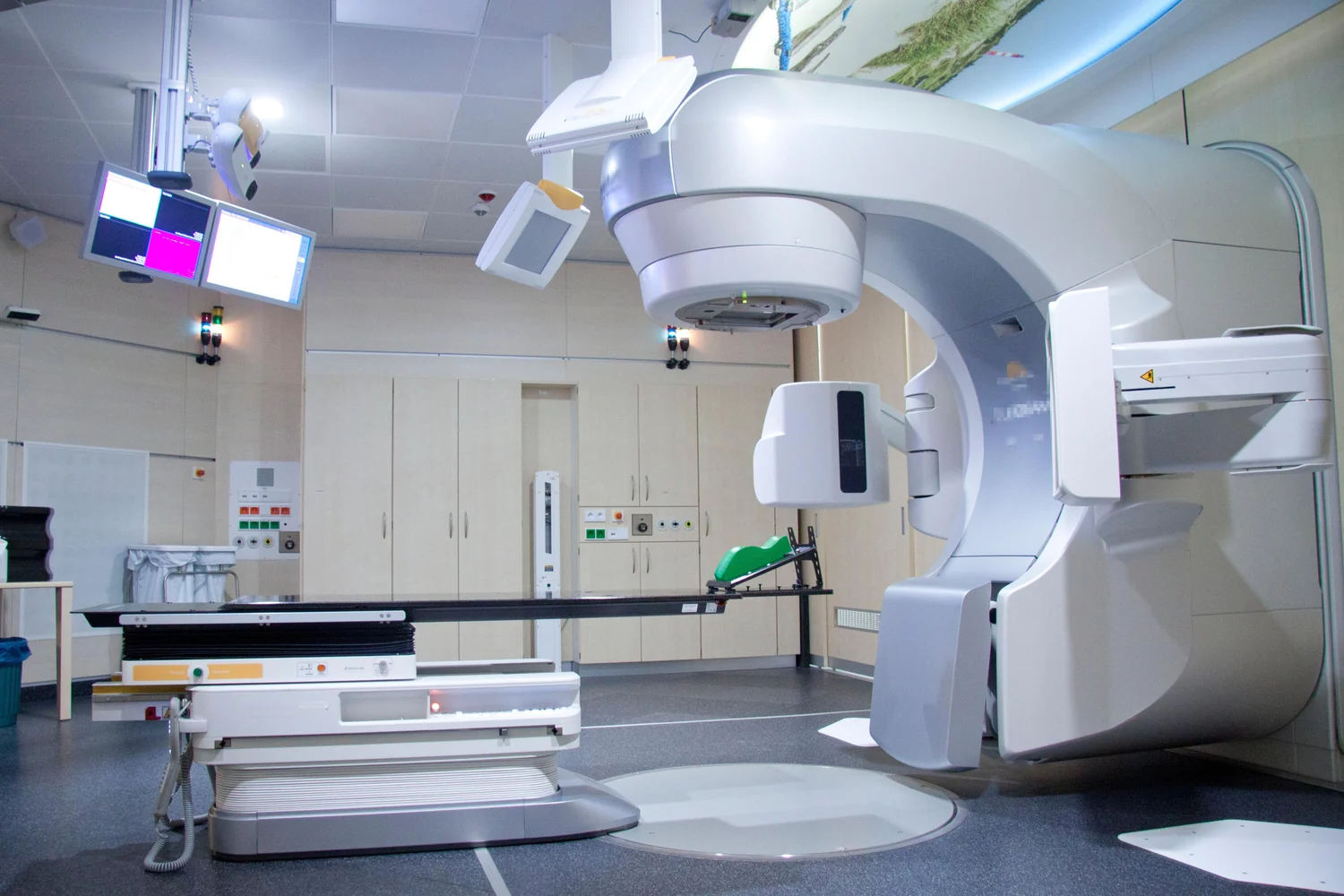 A radiotherapy linear accelerator with its treatment couch and imaging attachments.