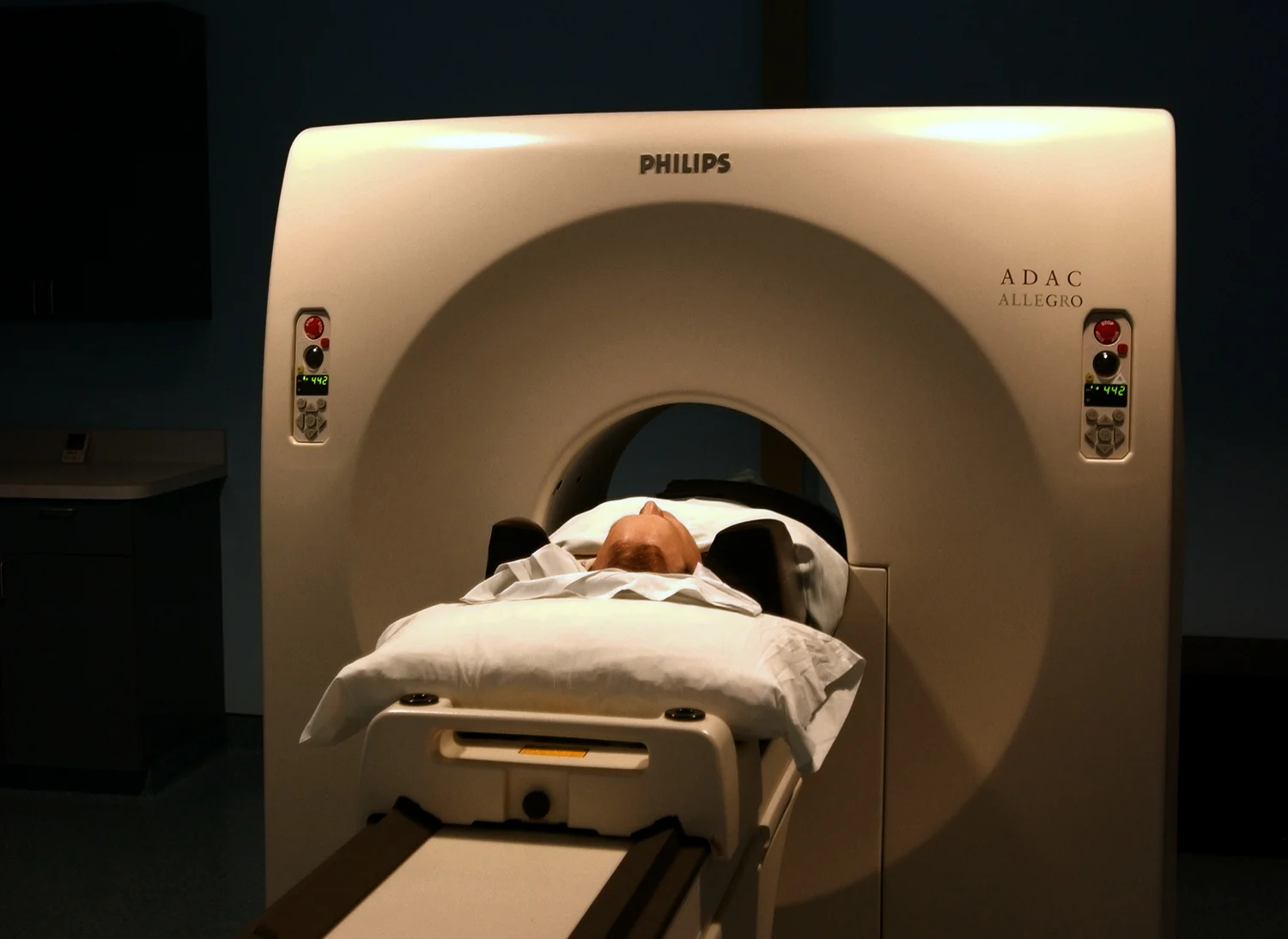 A patient passes through a PET scanner at a naval medical center.