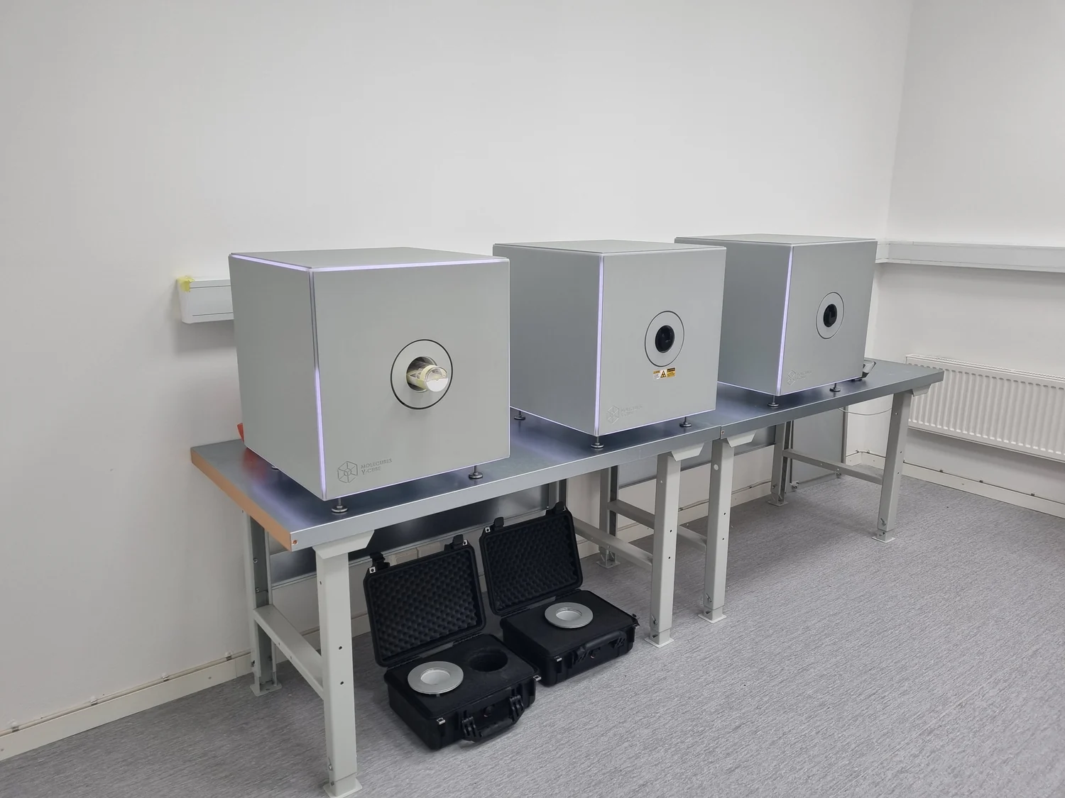 Compact preclinical SPECT, micro-CT, and PET imaging systems on a laboratory bench.