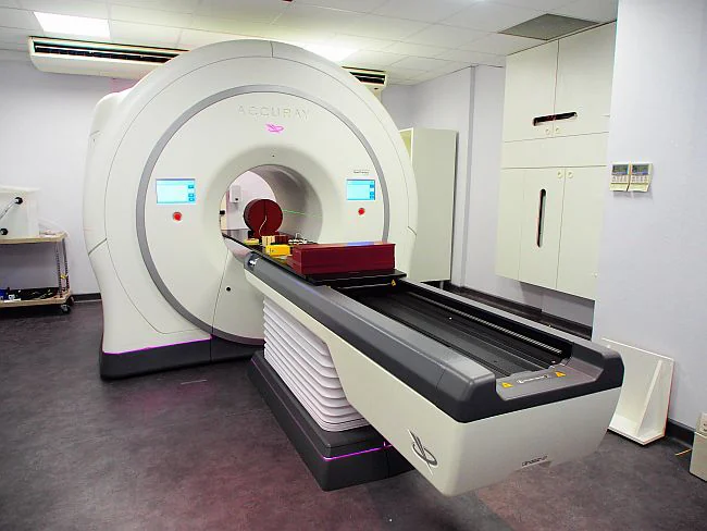 A ring-shaped TomoTherapy system and patient couch.